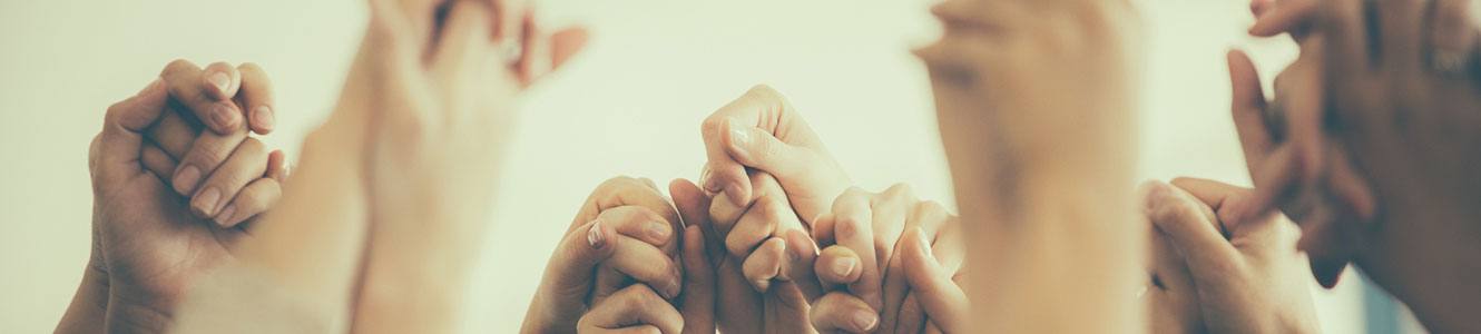 Group holding up hands together